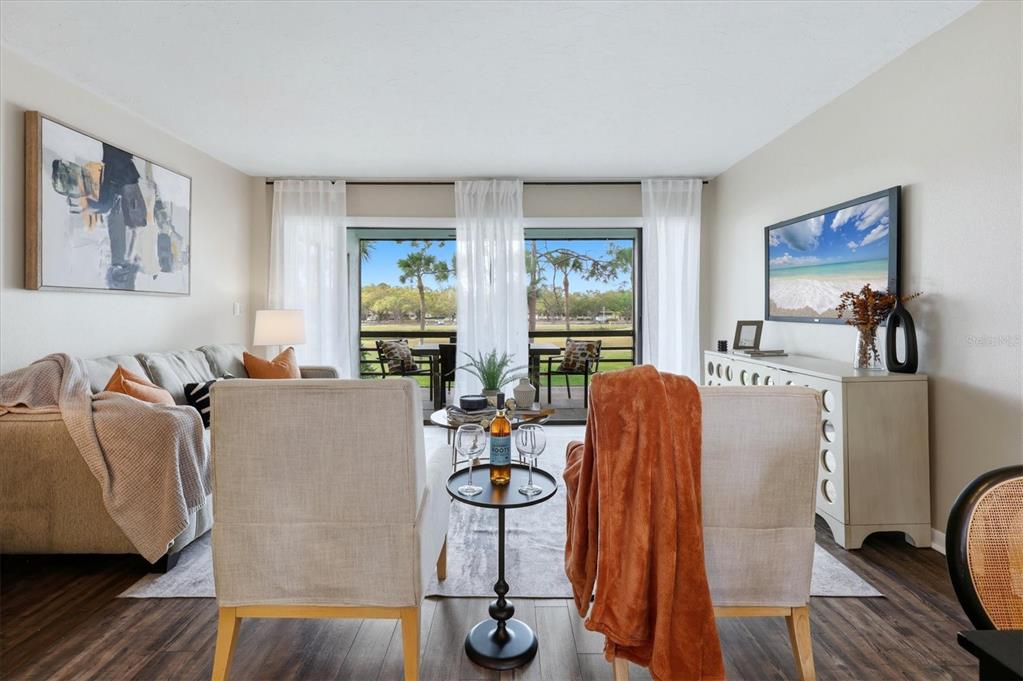 5058 Marsh Field Road, Unit 8 Sarasota, FL 34235 - Photo 3 of 73 a living room with furniture a window and gym equipment