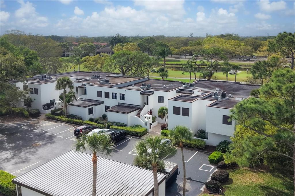 5058 Marsh Field Road, Unit 8 Sarasota, FL 34235 - Photo 31 of 73 an aerial view of a house with a yard patio and lake view