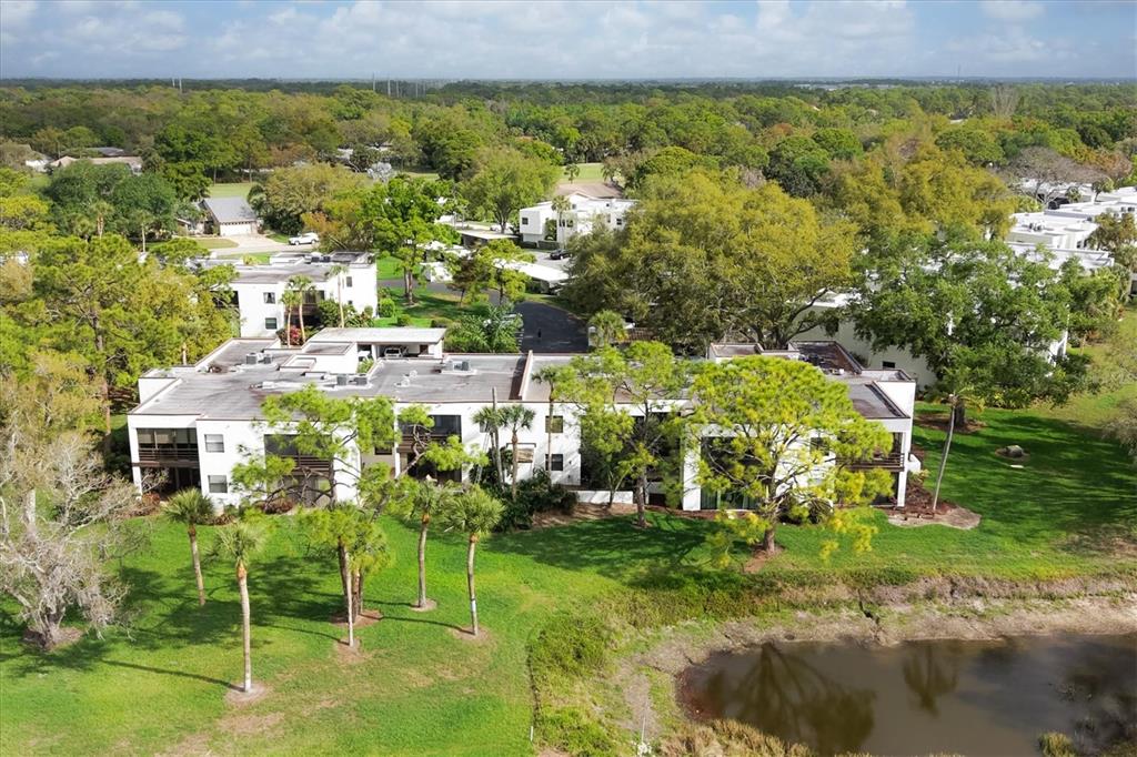 5058 Marsh Field Road, Unit 8 Sarasota, FL 34235 - Photo 32 of 73 a view of a city with lawn chairs and large trees