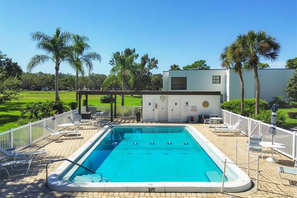 5058 Marsh Field Road, Unit 8 Sarasota, FL 34235 - Photo 37 of 73 a view of a backyard with a patio and swimming pool