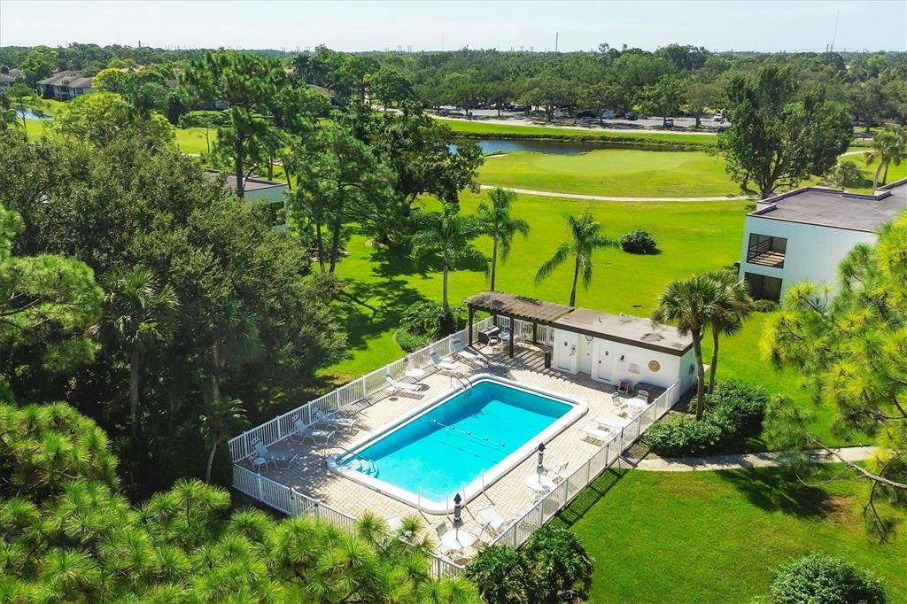 5058 Marsh Field Road, Unit 8 Sarasota, FL 34235 - Photo 39 of 73 a view of a tennis ground with a swimming pool