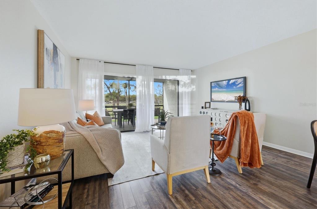 5058 Marsh Field Road, Unit 8 Sarasota, FL 34235 - Photo 4 of 73 a view of a workspace with furniture and wooden floor