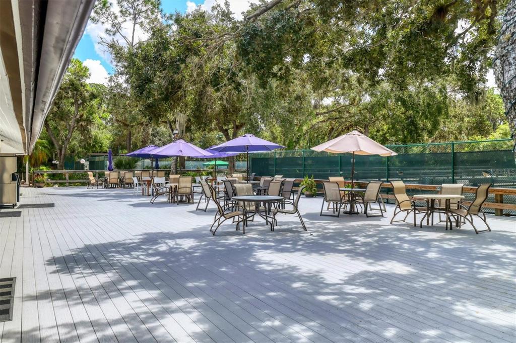 5058 Marsh Field Road, Unit 8 Sarasota, FL 34235 - Photo 57 of 73 an outdoor space with patio and white umbrellas