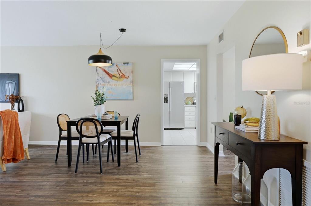 5058 Marsh Field Road, Unit 8 Sarasota, FL 34235 - Photo 7 of 73 a view of a dining room with furniture and wooden floor