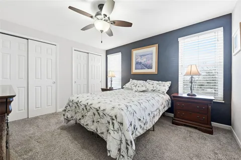 a bedroom with a bed and a dresser with mirror