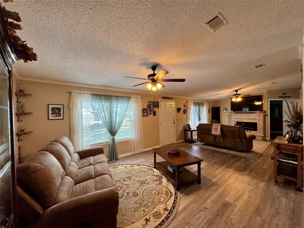 19580 Northwest 80th Drive Okeechobee, FL 34972 - Photo 25 of 34 a living room with furniture and a chandelier