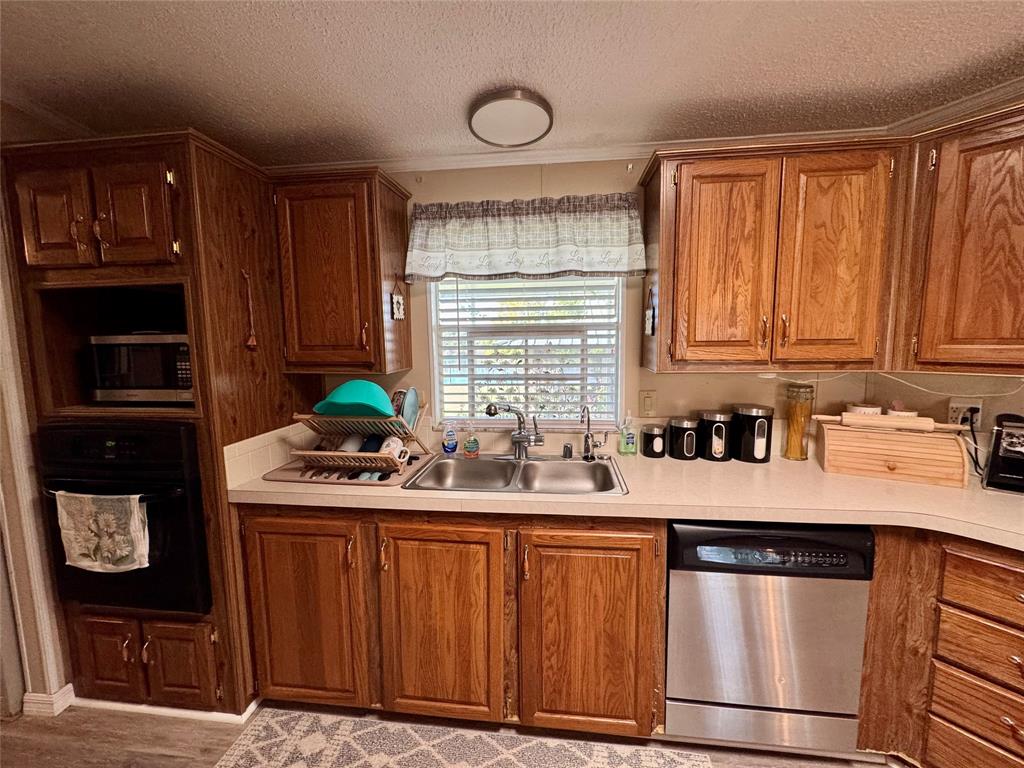 19580 Northwest 80th Drive Okeechobee, FL 34972 - Photo 29 of 34 a kitchen with stainless steel appliances granite countertop a sink stove and cabinets