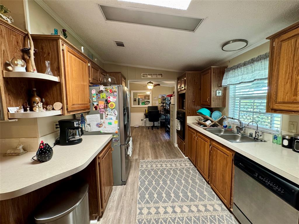 19580 Northwest 80th Drive Okeechobee, FL 34972 - Photo 31 of 34 a kitchen with lots of counter top space and wooden floor