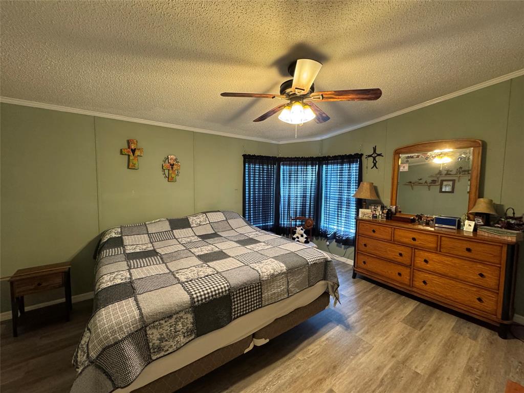 19580 Northwest 80th Drive Okeechobee, FL 34972 - Photo 34 of 34 a bedroom with a bed and a chandelier