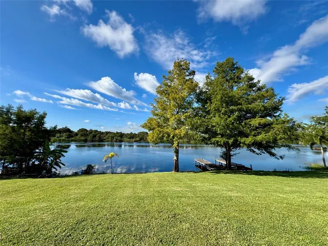 a view of a lake with houses in the back