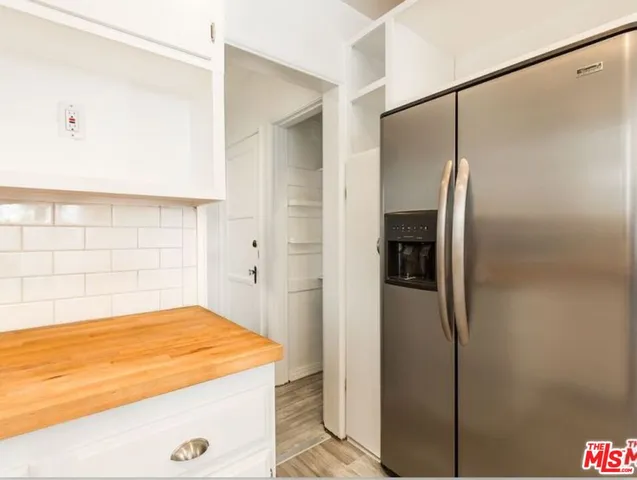 a view of a room with wooden floor and a window