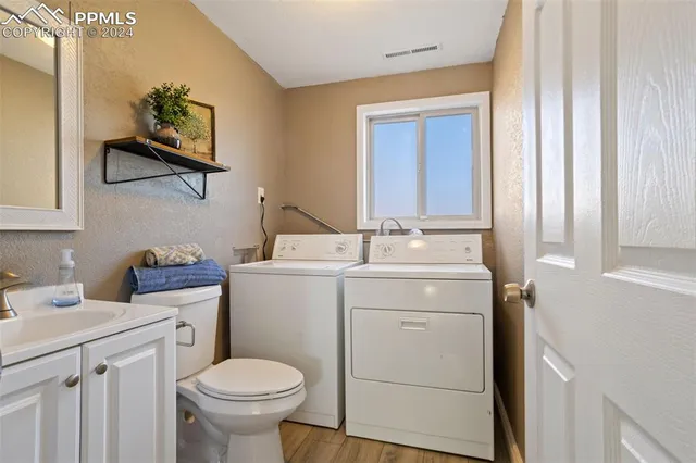 a bathroom with a sink toilet and a mirror