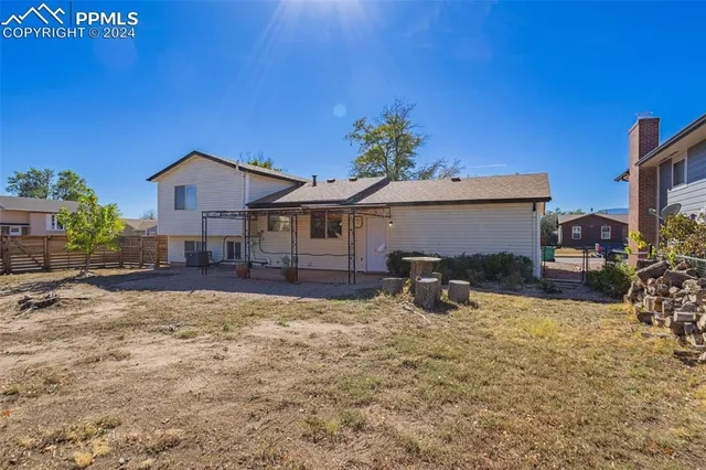a view of a house with yard and sitting area