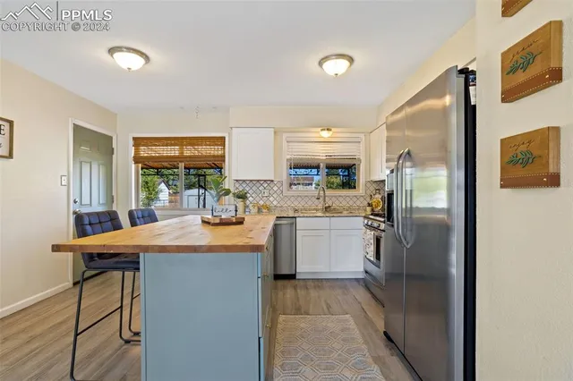 a kitchen with refrigerator and cabinets