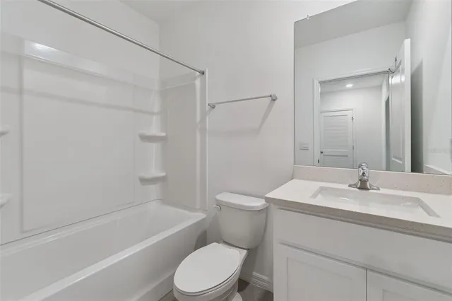 a view of kitchen with kitchen island a sink stainless steel appliances and cabinets