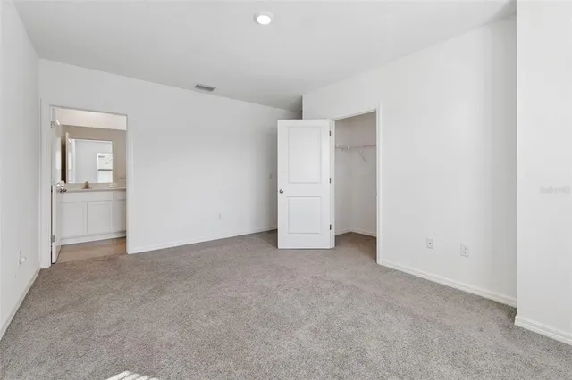 an empty room with closet and natural light