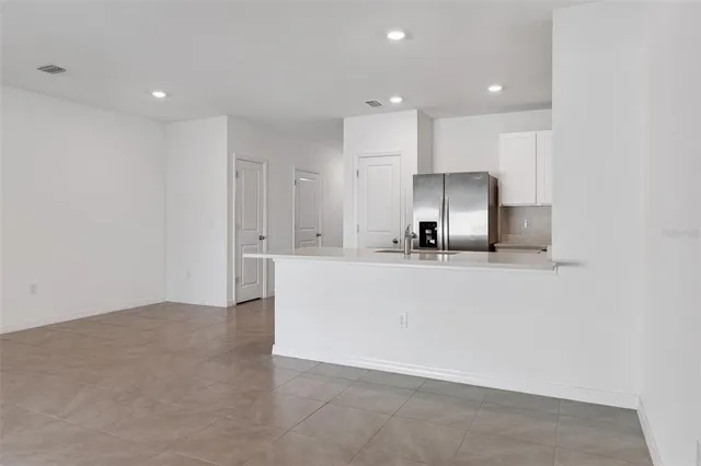 a view of kitchen with kitchen island and stainless steel appliances