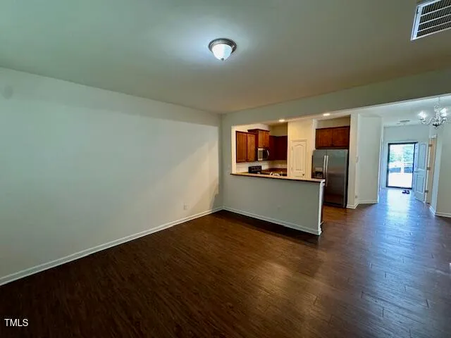 a living room with hard wood floors and a window