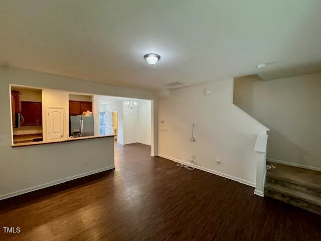a metallic refrigerator freezer sitting in a kitchen