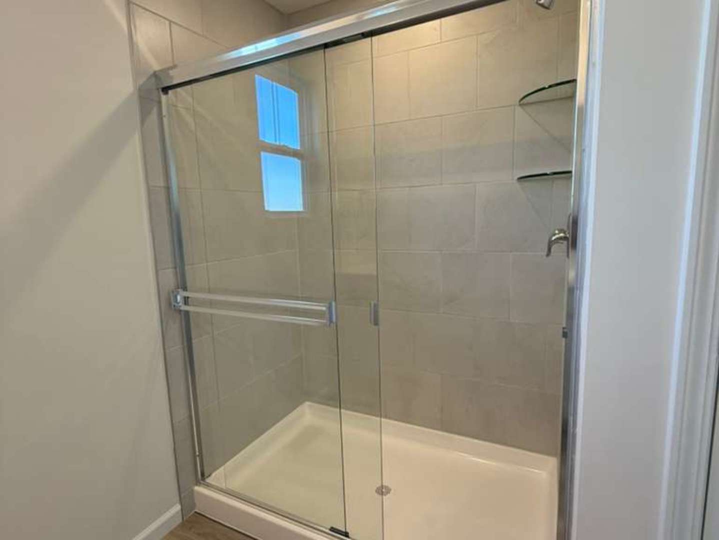 672 Switchgrass Way, Unit 58005 Bolingbrook, IL 60490 - Photo 14 of 19 a bathroom with a glass shower door