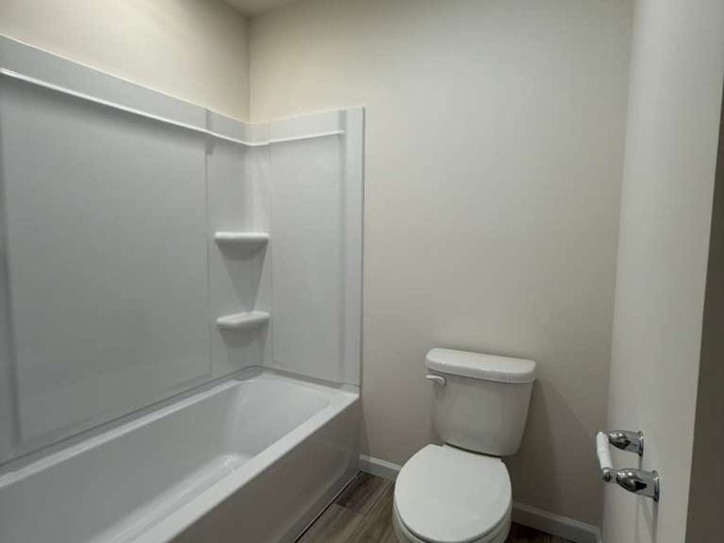 672 Switchgrass Way, Unit 58005 Bolingbrook, IL 60490 - Photo 15 of 19 a white toilet sitting next to a bath tub
