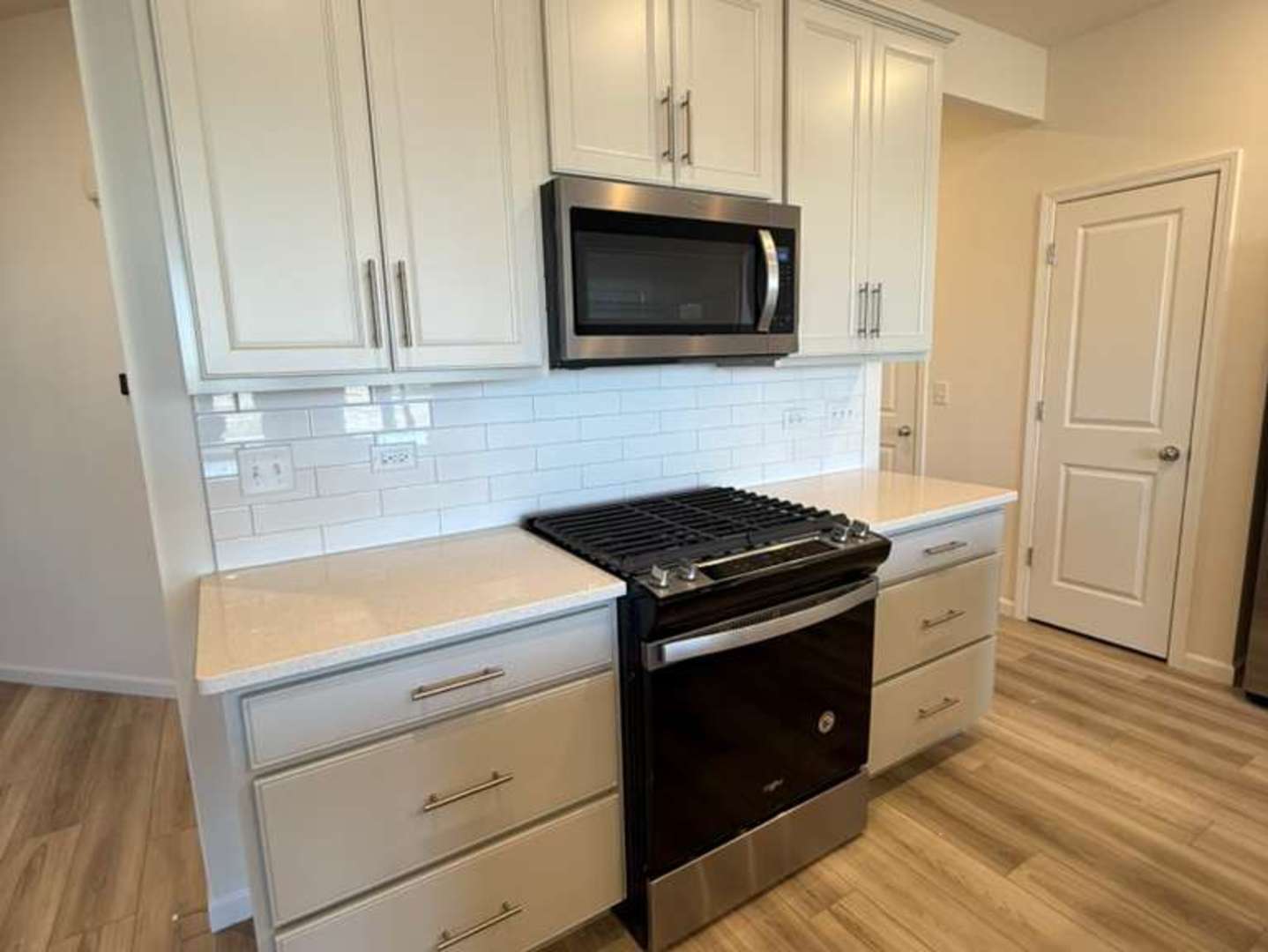 672 Switchgrass Way, Unit 58005 Bolingbrook, IL 60490 - Photo 2 of 19 a kitchen with a stove microwave and sink