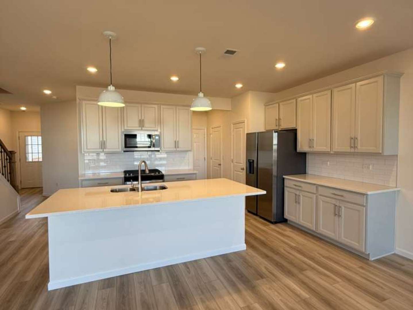 672 Switchgrass Way, Unit 58005 Bolingbrook, IL 60490 - Photo 4 of 19 a large kitchen with stainless steel appliances granite countertop a sink a stove and a refrigerator