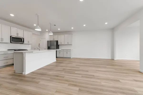 a view of kitchen with granite countertop stainless steel appliances refrigerator oven stove microwave and cabinets