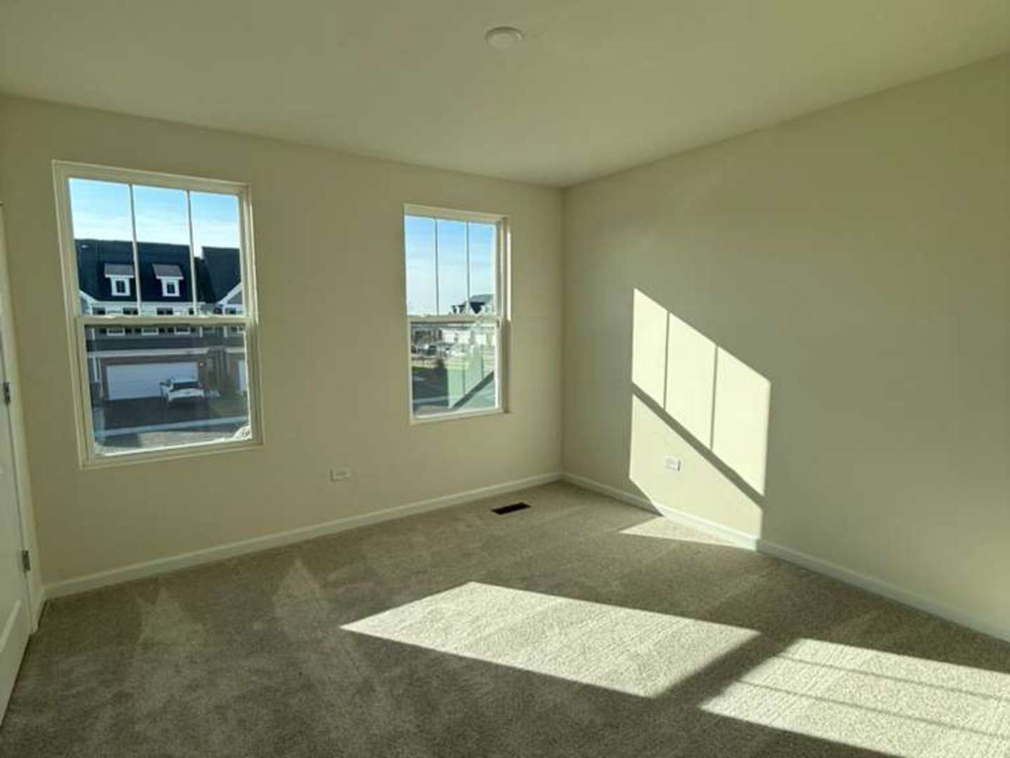 672 Switchgrass Way, Unit 58005 Bolingbrook, IL 60490 - Photo 8 of 19 a view of an empty room and window