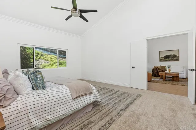 a bedroom with a large bed and a chandelier