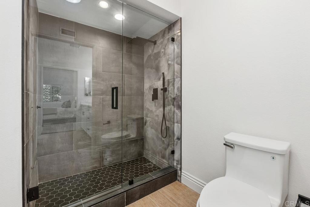 13611 Penina Street Poway, CA 92064 - Photo 17 of 30 a bathroom with a shower and toilet