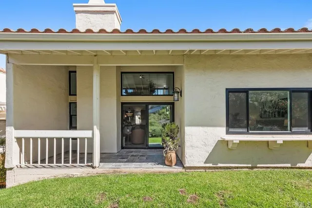 a view of a house with a swimming pool and a yard