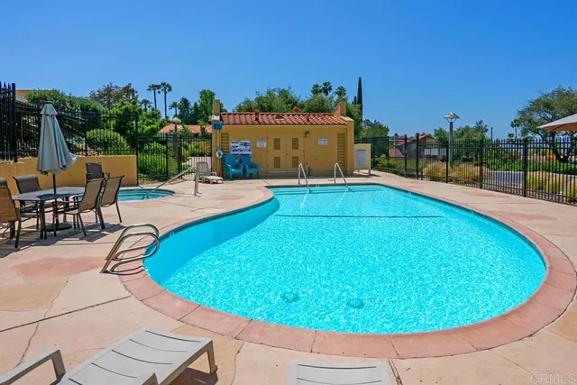 a view of a swimming pool with an outdoor seating
