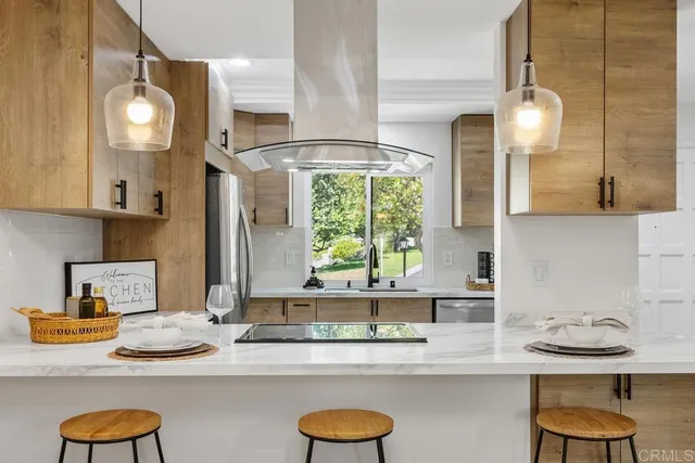 a kitchen with granite countertop a sink and a stove with wooden floor