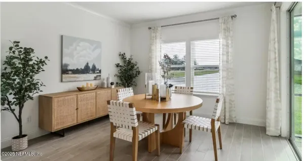 a dining room with furniture and wooden floor