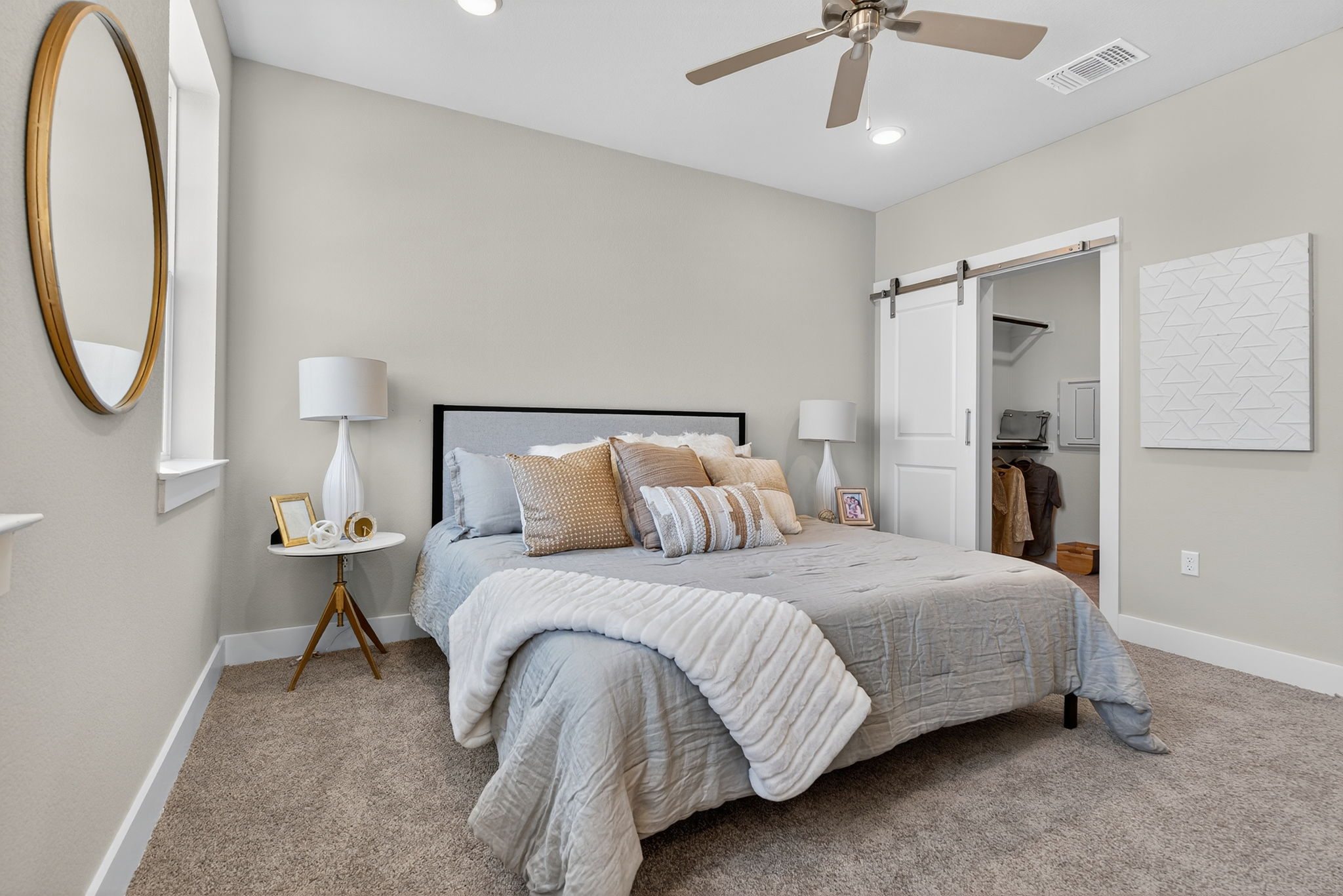 5904 Rotunda View Austin, TX 78747 - Photo 21 of 37 Carpeted bedroom with a barn door, a walk in closet, ceiling fan, and recessed lighting