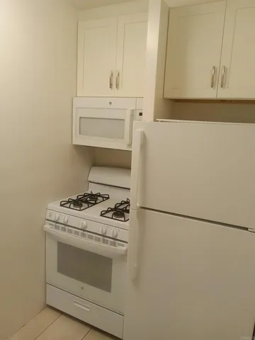 a kitchen with a stove and a refrigerator