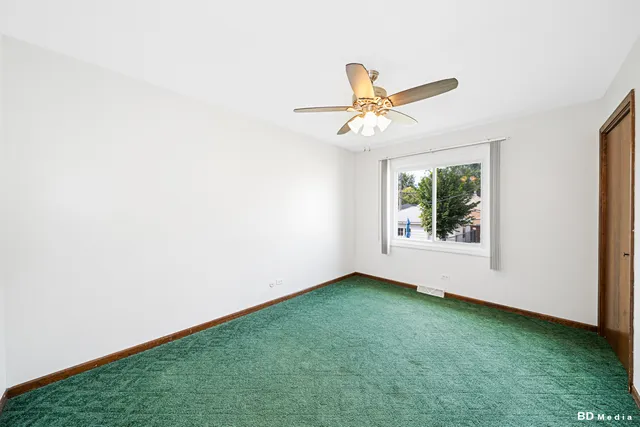a view of room with window and ceiling fan