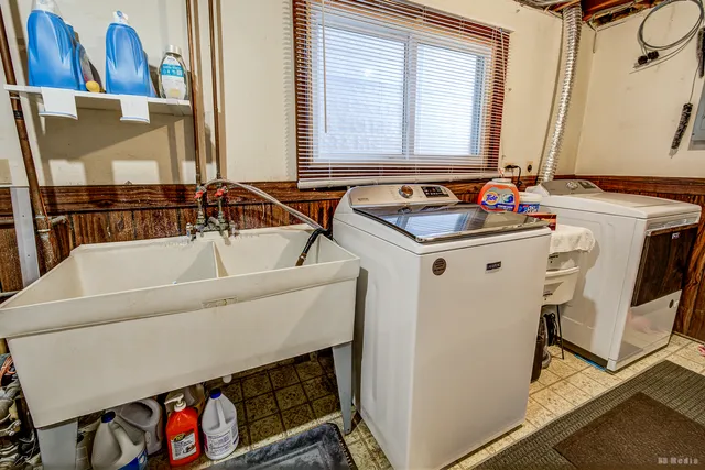a bathroom with a tub a sink and a mirror