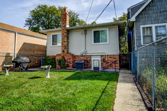 a view of a house with a yard and sitting area