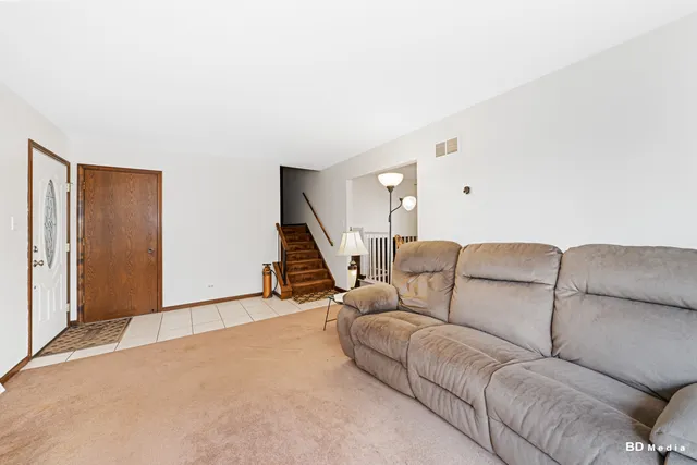 a living room with furniture and a ceiling fan
