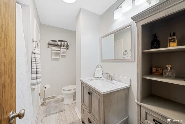 a bathroom with a sink a toilet and a mirror