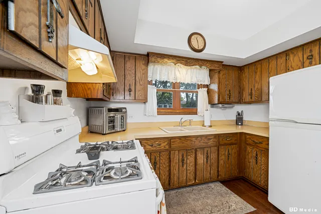 a kitchen with a sink cabinets and window