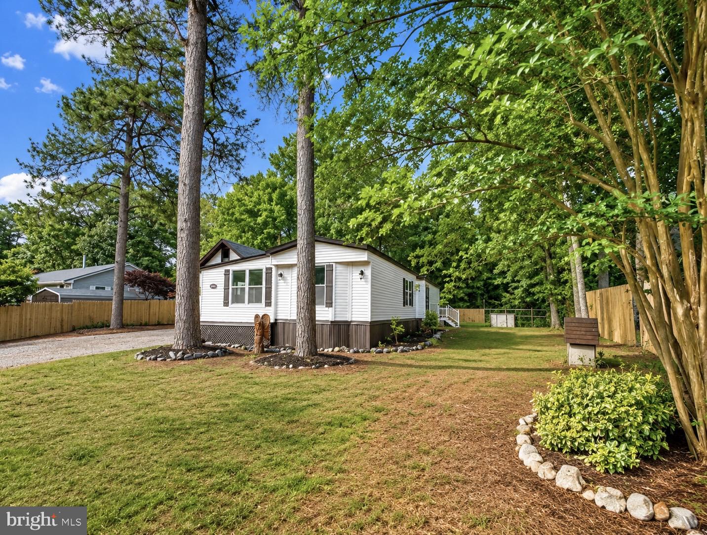26465 Mason Webster Road Princess Anne, MD 21853 - Photo 33 of 56 a front view of a house with a garden and trees