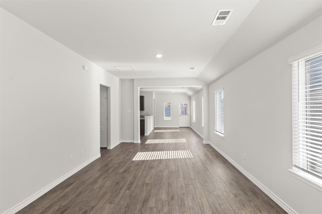 1505 Romans Road Ennis, TX 75119 - Photo 3 of 13 a view of a big room with wooden floor and windows