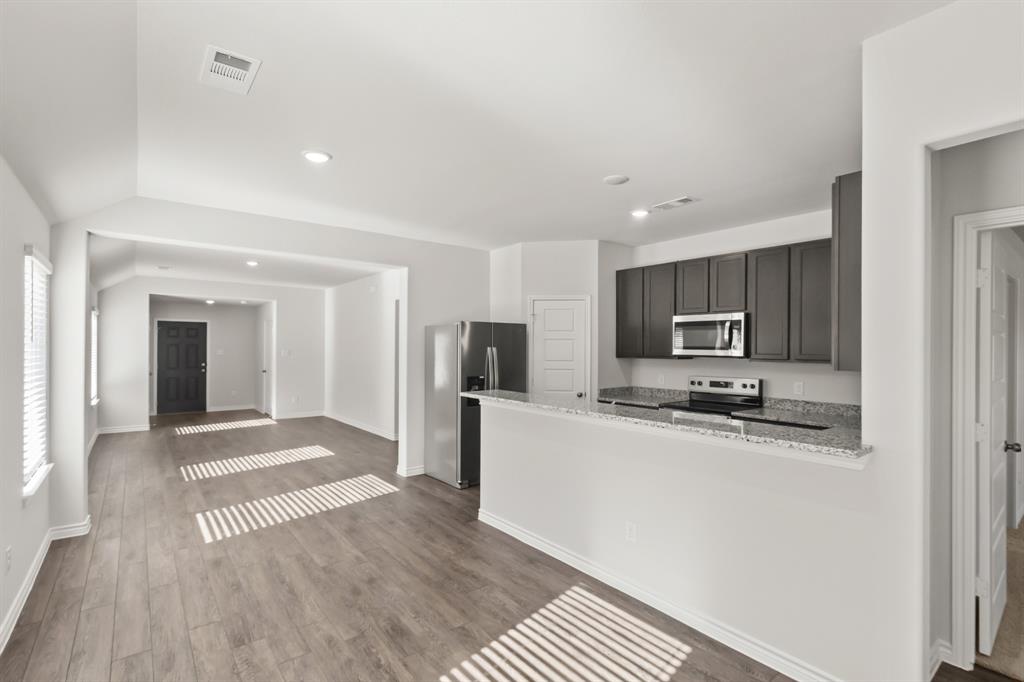 1505 Romans Road Ennis, TX 75119 - Photo 4 of 13 a kitchen with stainless steel appliances a refrigerator and a stove top oven