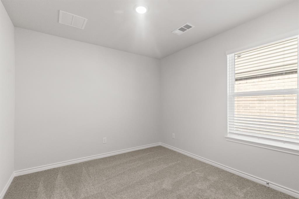 1505 Romans Road Ennis, TX 75119 - Photo 9 of 13 an empty room with a window