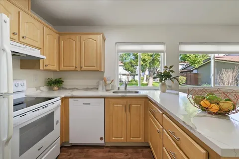 a kitchen with a sink stove and cabinets