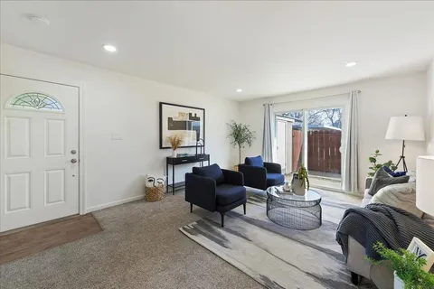 a living room with furniture and a large window