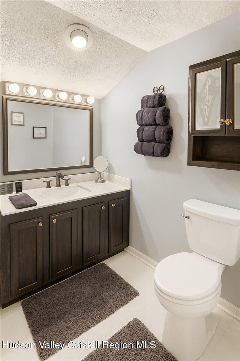 266 Scheller Park Road West Coxsackie, NY 12192 - Photo 12 of 26 a bathroom with a toilet a sink and mirror